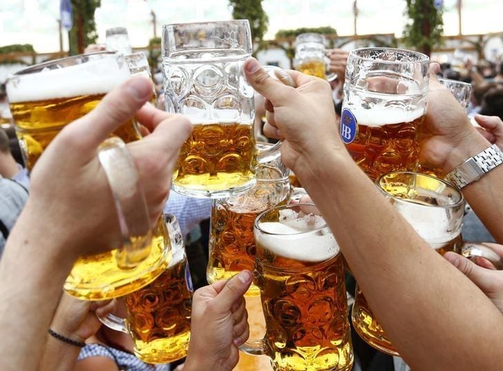 Visitors toast with beer on the first day of the 182nd Oktoberfest in Munich