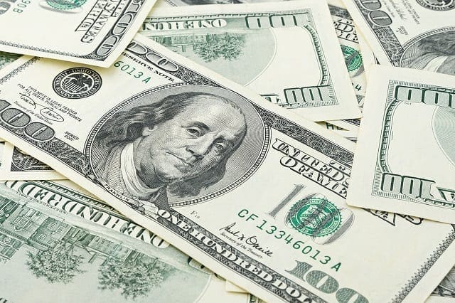 Wallpaper background closeup American money hundred dollar bill. Many US 100 banknote