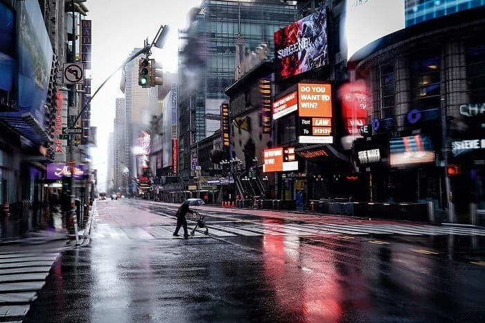 Person with a walker crosses 42nd Street in Manhattan