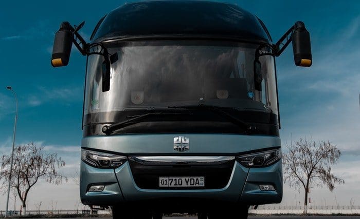 pexels-timcompound-3608967 Visão frontal de um ônibus de fretamento para viagem estacionado.