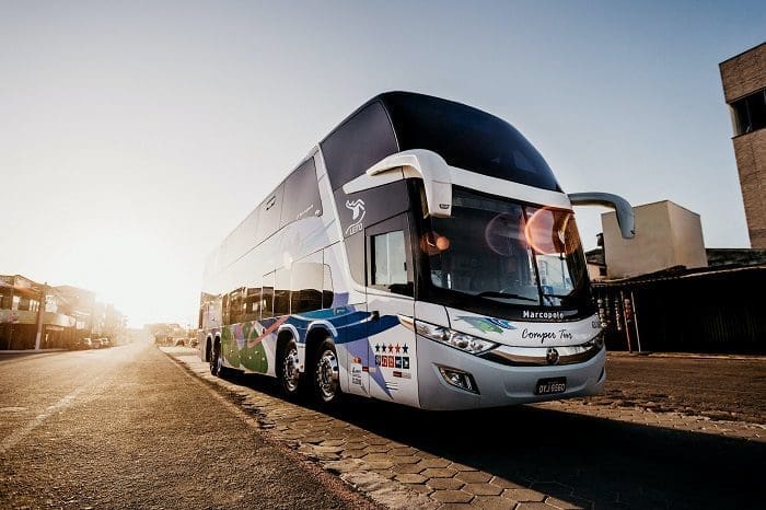 jonathan-borba-LR5O79shvro-unsplash Foto de um ônibus de viagem na estrada. A projeção da Abrati é que, para viajar de ônibus para aproveitar o Carnaval 2023, a oferta crescerá 25%